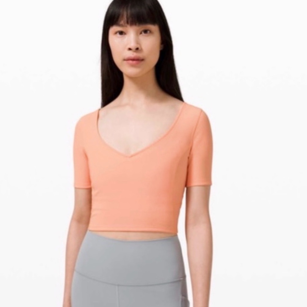 NWOT Lululemon Ribbed Contoured V-Neck Yoga
Short Sleeve, Malibu Peach, Size 6